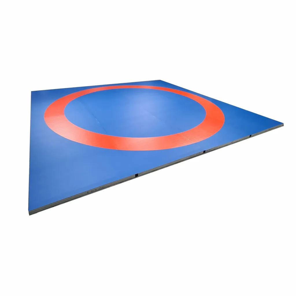 Blue wrestling roll out mat area with a large red circular ring on a smooth PVC surface.
