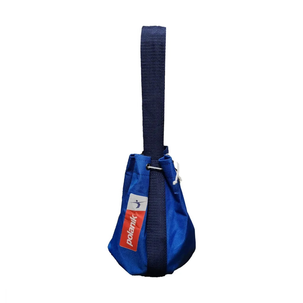 Blue fabric hammer ball bag hanging from a long navy strap, with a white drawstring, metal grommet, and a red-and-white tag.
