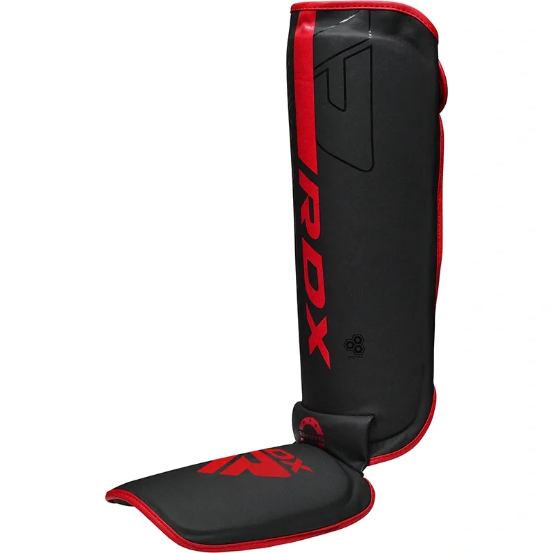 Black shin and instep guard with red trim and RDX printed vertically on the shin.