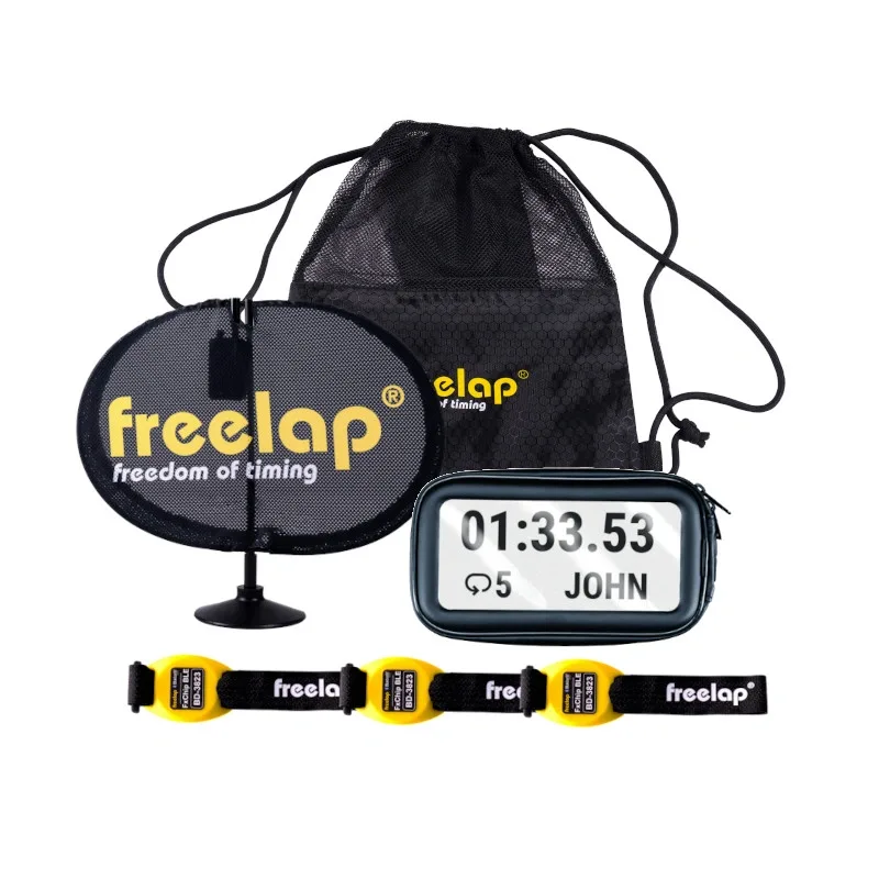 Motocross timing kit with black mesh bag, pop-up sensor freelap freedom of timing, display showing 01:33.53 JOHN and three yellow wrist tags.