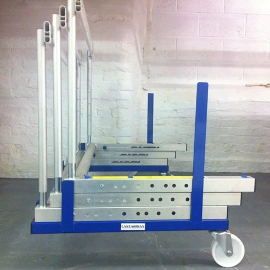Blue polyester powder-coated steel trolley holding stacked silver hurdles on vertical supports with a white caster wheel.