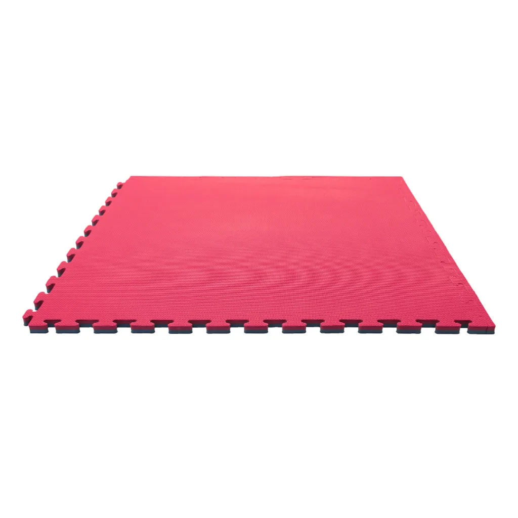 Red foam jigsaw mat with blue underside visible at interlocking edges and textured surface, shown flat on a white background.