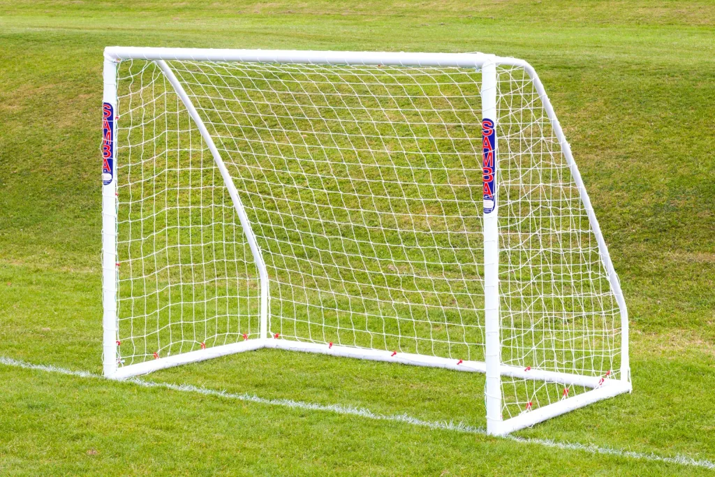 White freestanding high-impact uPVC soccer goal with net on grass, uprights labeled SAMBA.