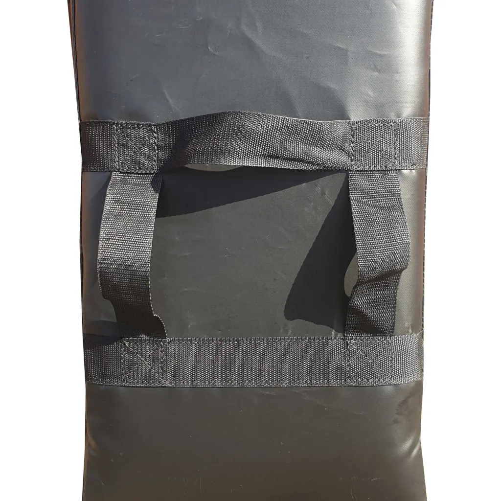 Strike pad with heavy-duty PVC cover, dual-density foam core, and two reinforced webbing hand straps on the back.