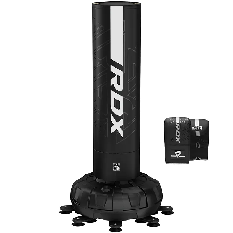 Black free-standing punching bag with tall cylindrical striking surface on a round weighted base and a pair of black training mitts beside it.