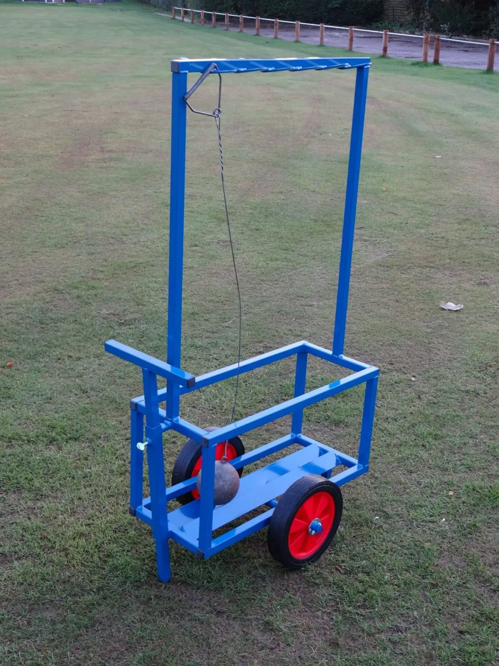 Blue powder-coated steel hammer trolley with tall frame, two large hard rubber wheels, a hanging hammer and push/pull handle, holds up to 12 hammers.