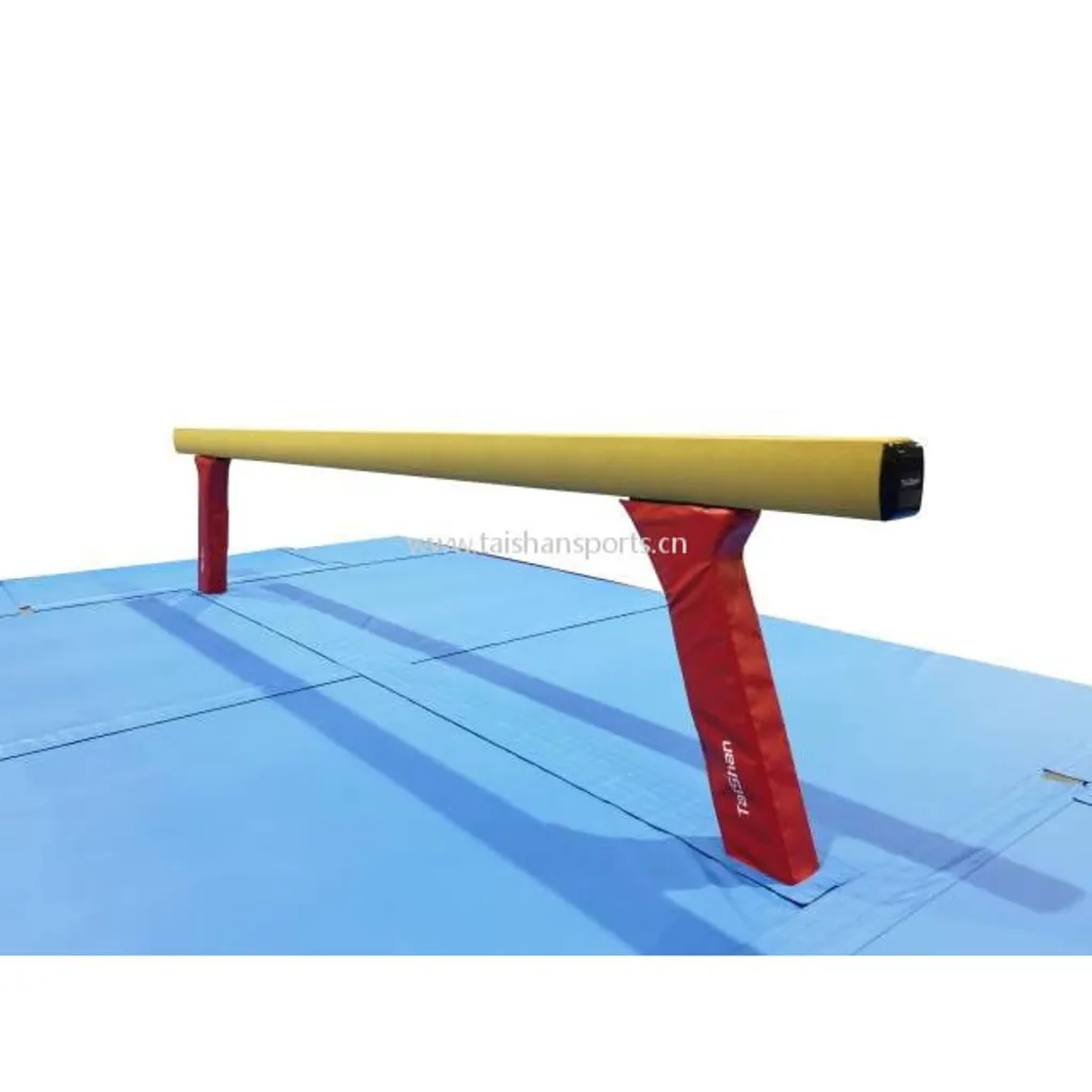 Yellow carbon fibre balance beam with padded non-slip surface on red legs over a blue mat, watermark "www.taishansports.cn" visible.