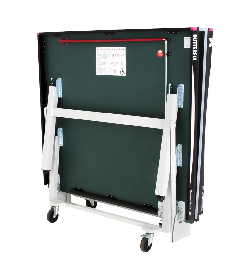 Centrefold 25 Rollaway table folded upright with green playing top, light silver legs and undercarriage, magenta corner pieces and caster wheels.