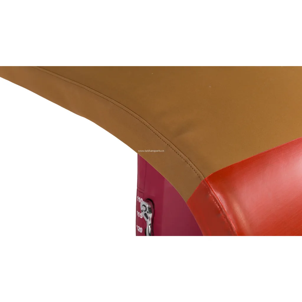 Vaulting table with red padded front, brown non-slip hand area with stitched seam and small text "www.taishansports.cn".