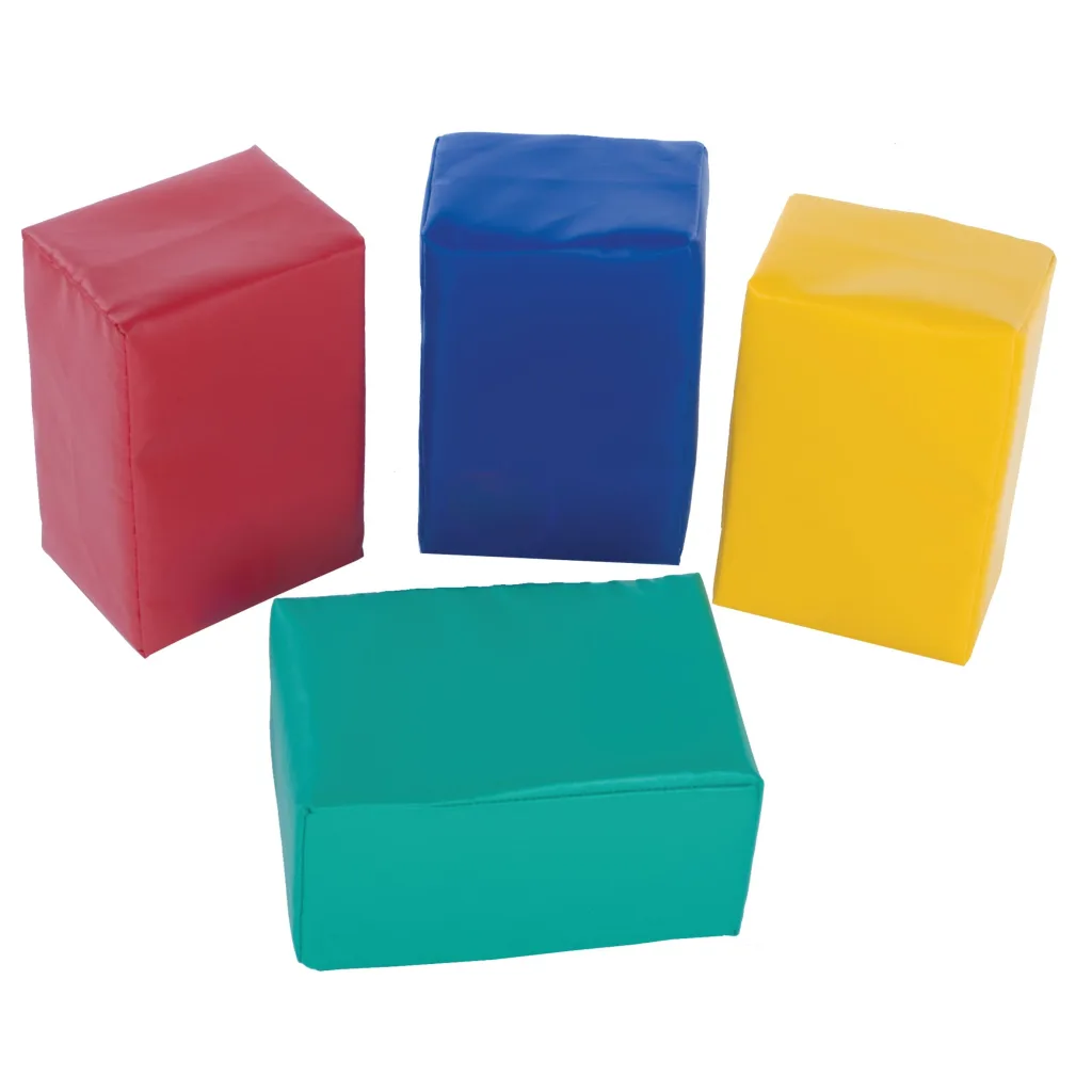 Three tall soft foam blocks in red, blue and yellow standing behind a low green foam square.