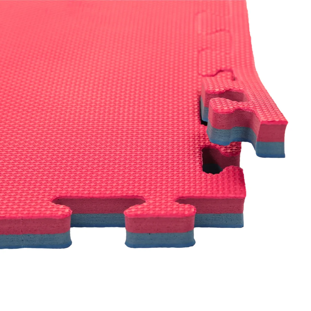 Red textured jigsaw mat with blue EVA foam underside and interlocking tabs visible at the edges.