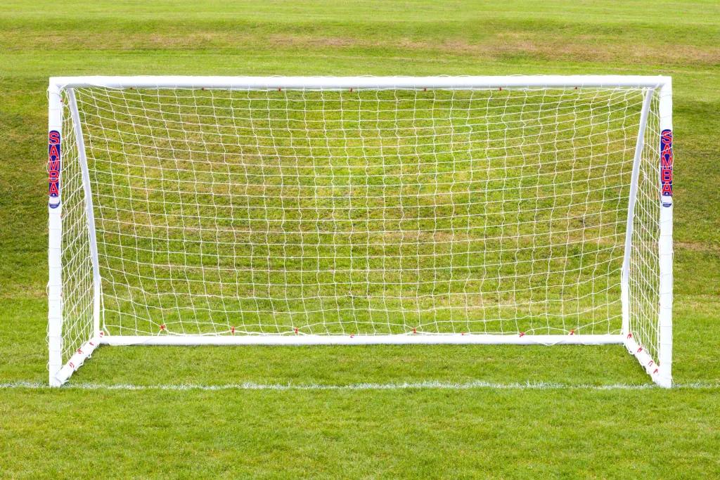 White freestanding match goal made from high-impact uPVC with a white net on green grass and SAMBA printed on both posts.