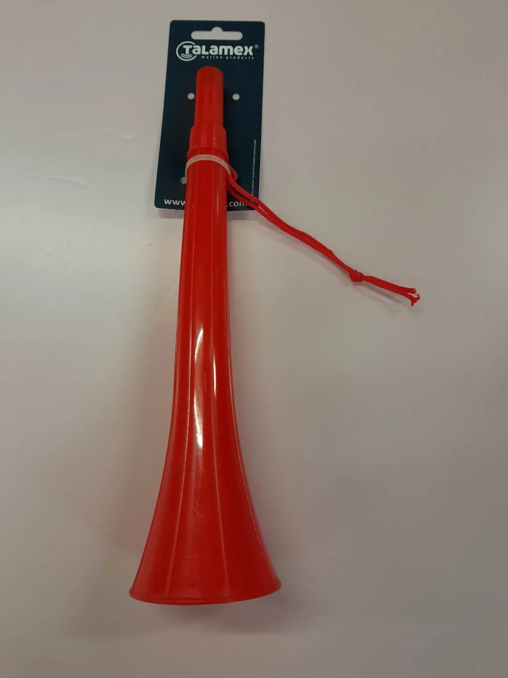 Red plastic warning horn with flared bell and attached red cord on a hanging display card.