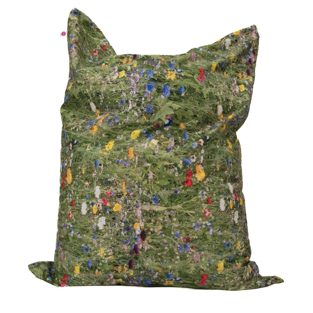 Soft 100% polyester cover printed with a green meadow pattern and small red, yellow and blue wildflowers on a large floor cushion.