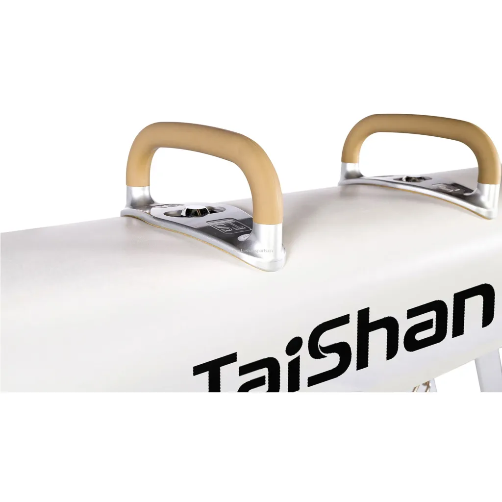 Red competition pommel horse top covered in genuine leather, showing two tan handles mounted on silver metal fittings.