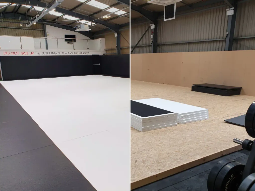 Gym interior with large white mat, dark border, stacked white/black panels, and a sign reading 'DO NOT GIVE UP THE BEGINNING IS ALWAYS THE HARDEST'.